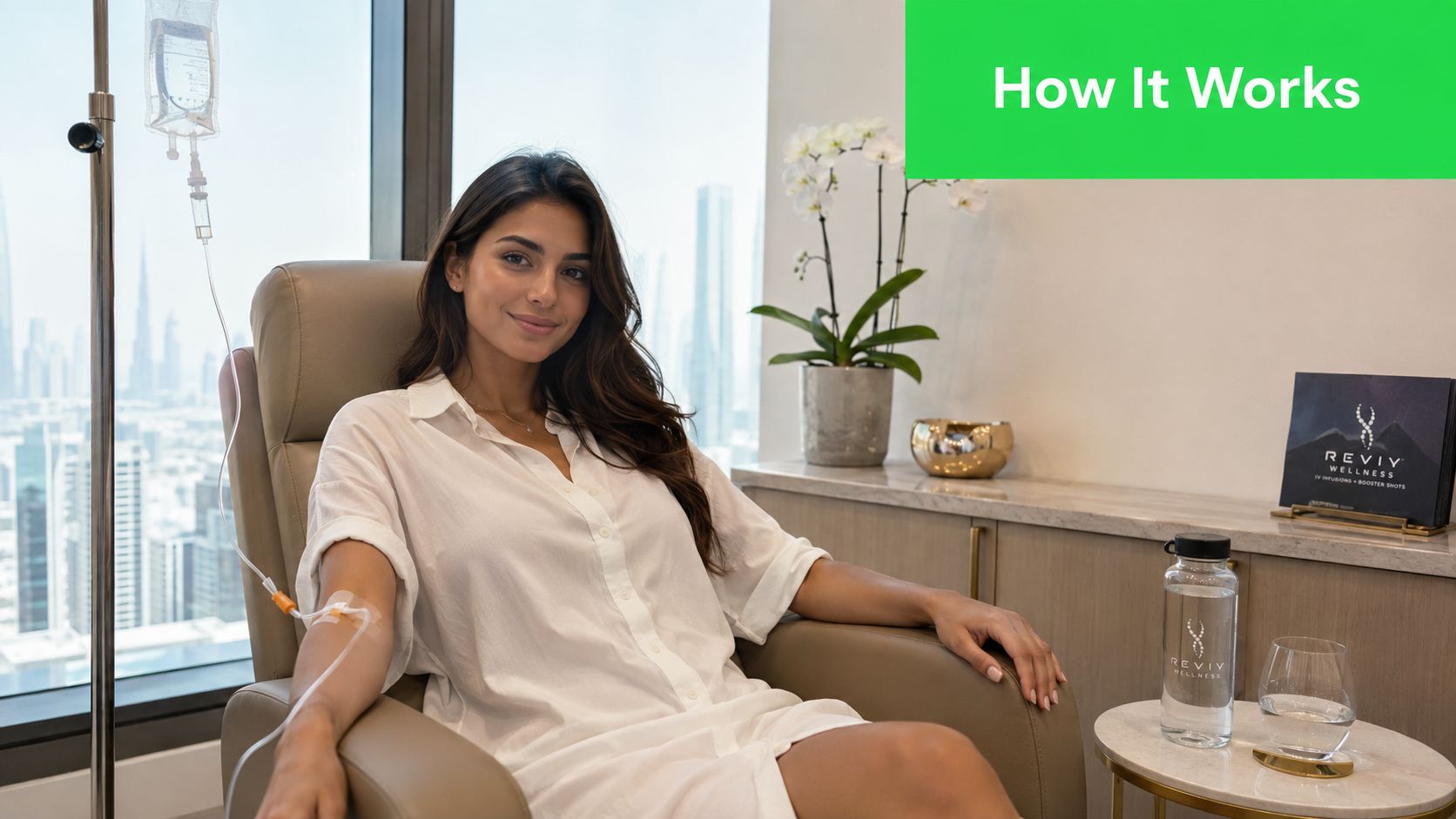 IV Drip Therapy in Dubai: Benefits, Safety, and At-Home Care 5 A smiling woman receives IV drip therapy in a comfortable clinic with a scenic city view.